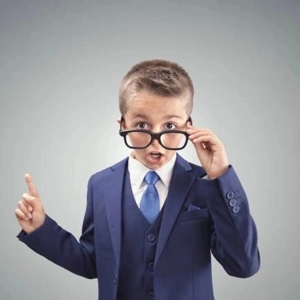 Young boy in suit with glasses