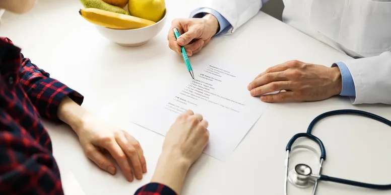 Patient and doctor reviewing documents