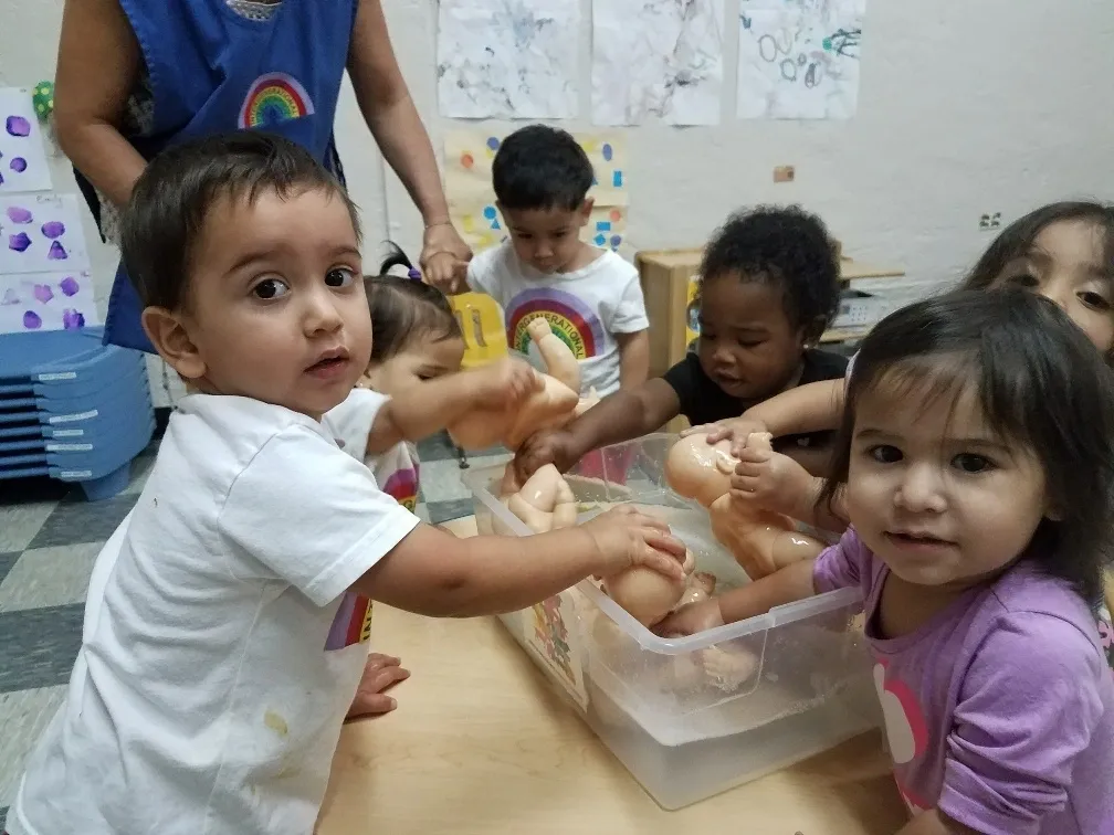 Kids washing dolls in tub
