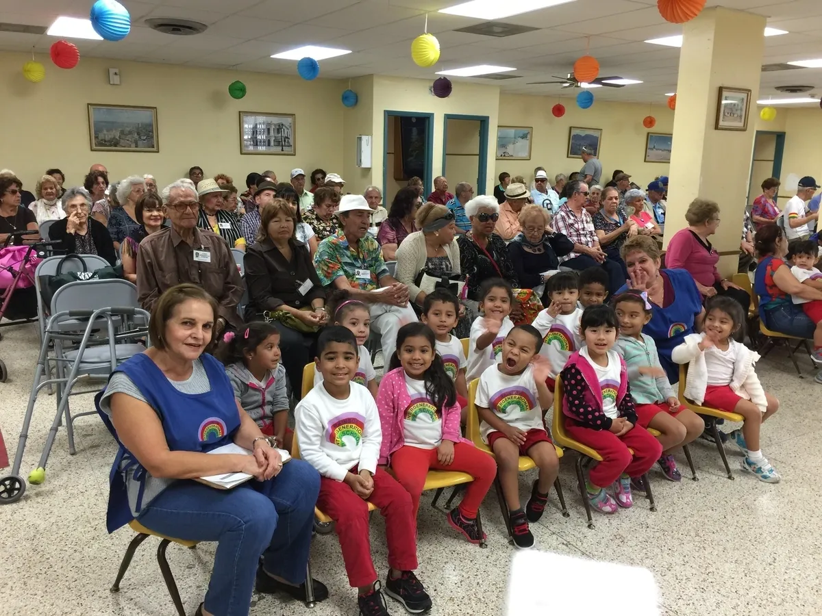 Kids and elders gathered in a hall