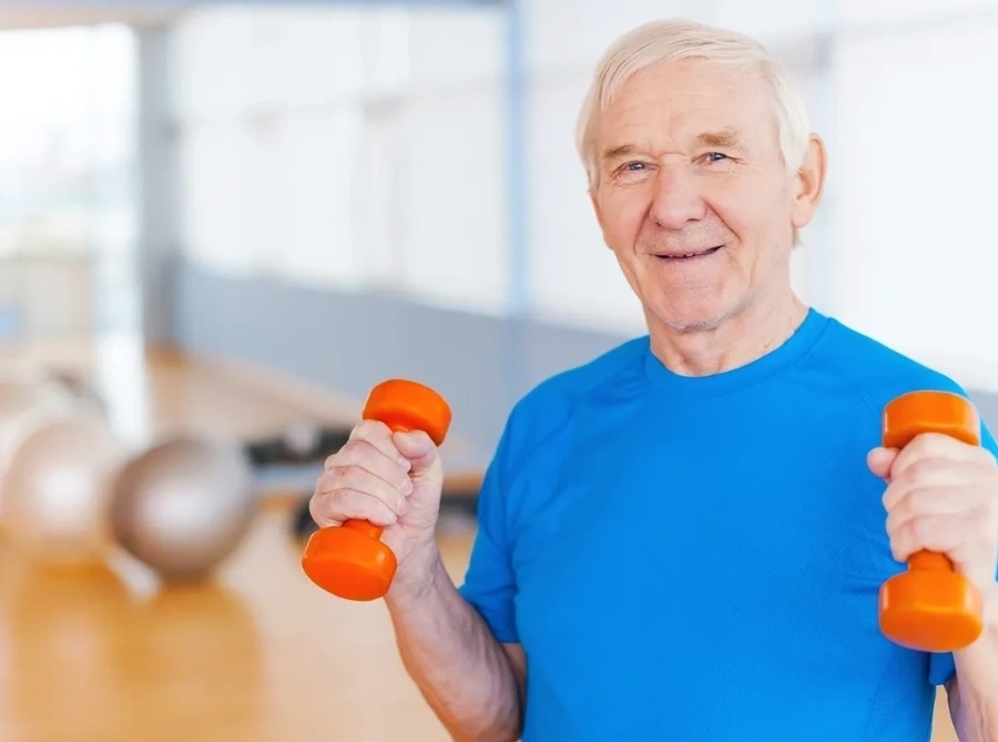 Senior man exercising with dumbbells