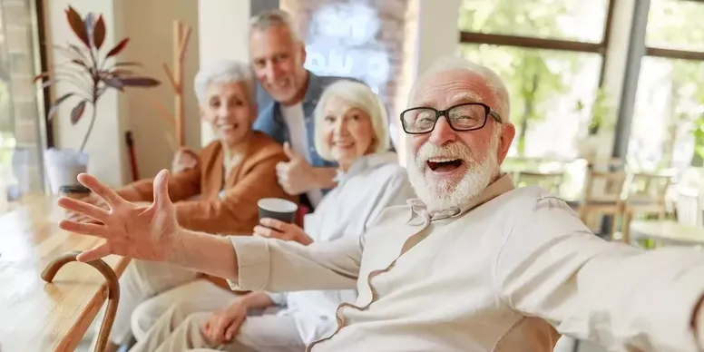 Elderly friends enjoying coffee and laughter