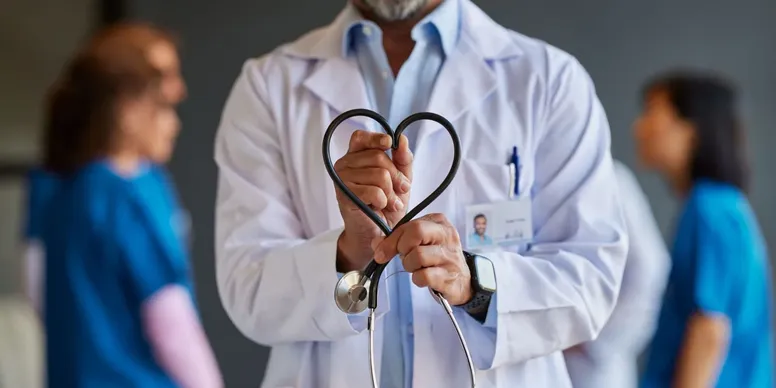 Healthcare worker holding stethoscope heart shape