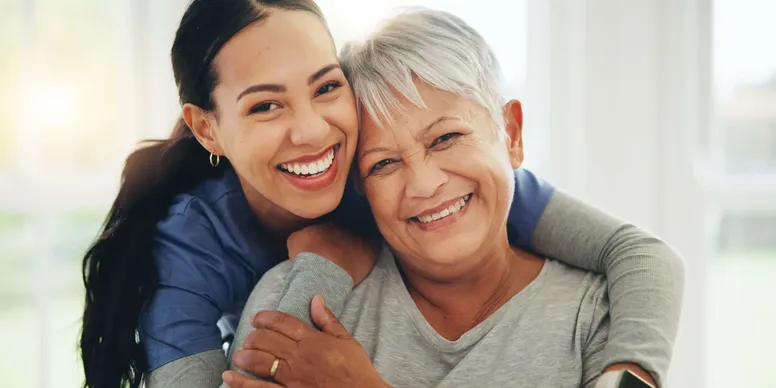 Smiling women embracing indoors