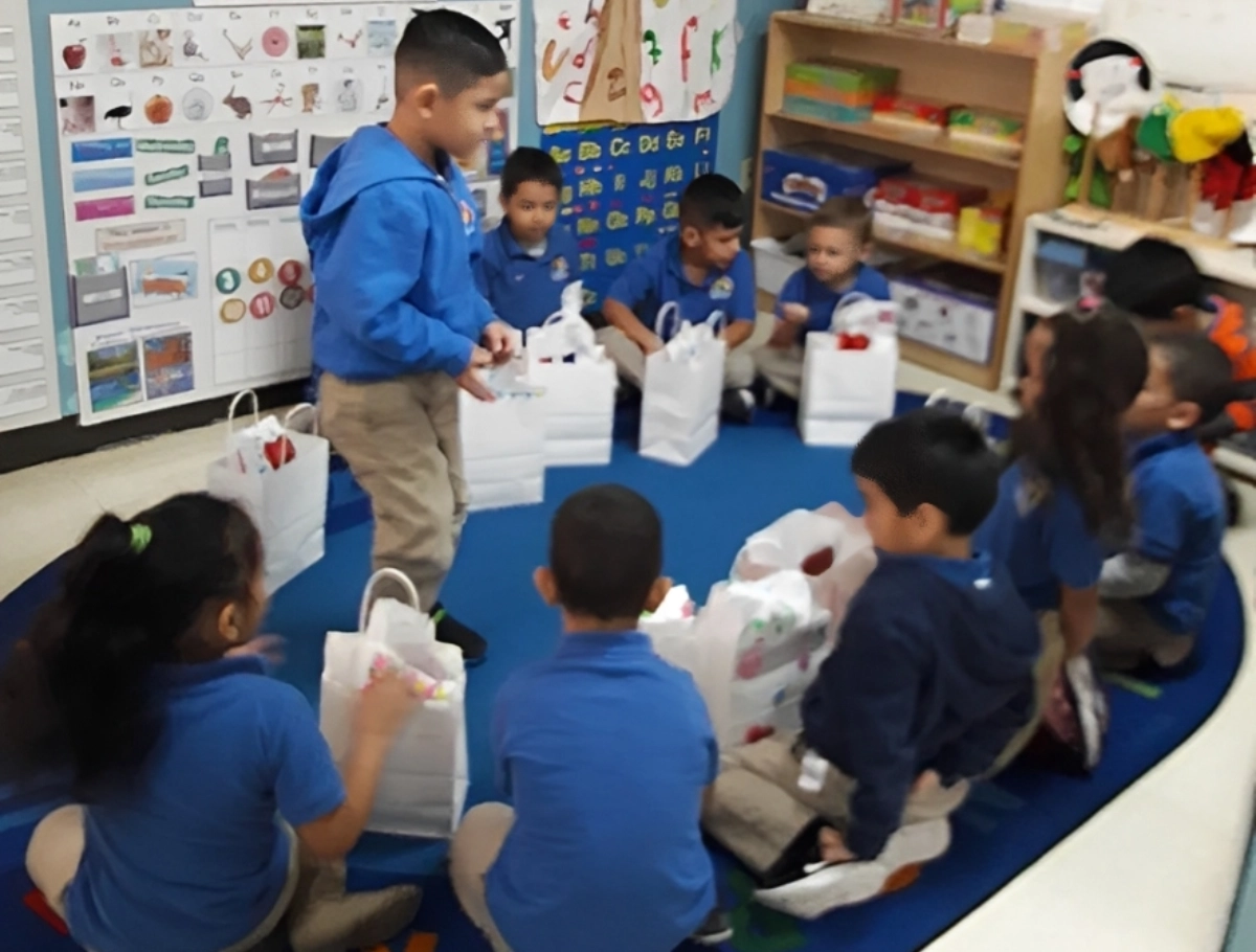 Children sitting in a circle with bags