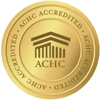 Gold ACHC accredited seal on black background